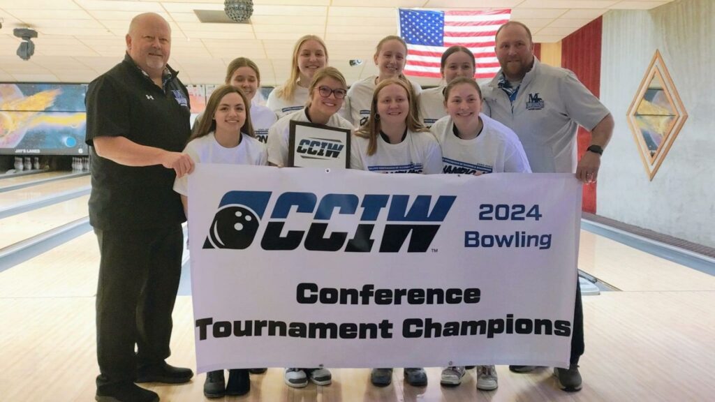 A college bowling team with large championship banner