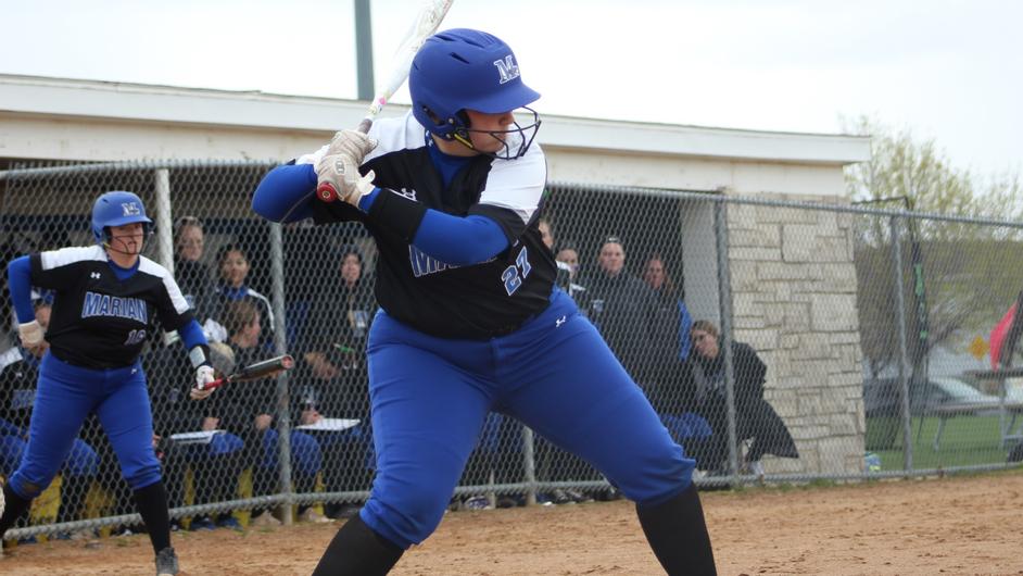 A woman batting in softball