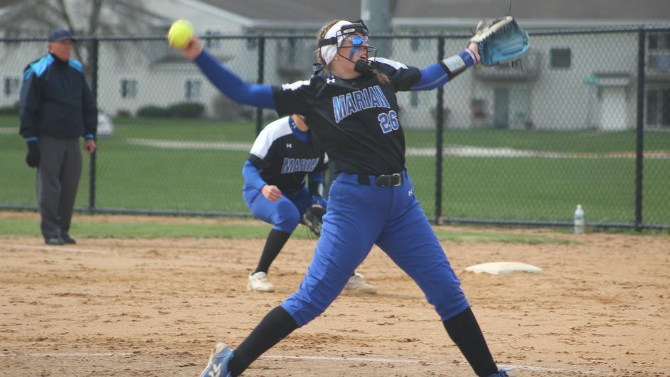 A female pitching a softball