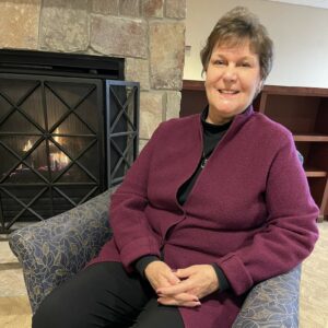 A middle aged woman sitting in a chair