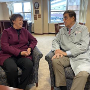 A woman sitting talking to a doctor