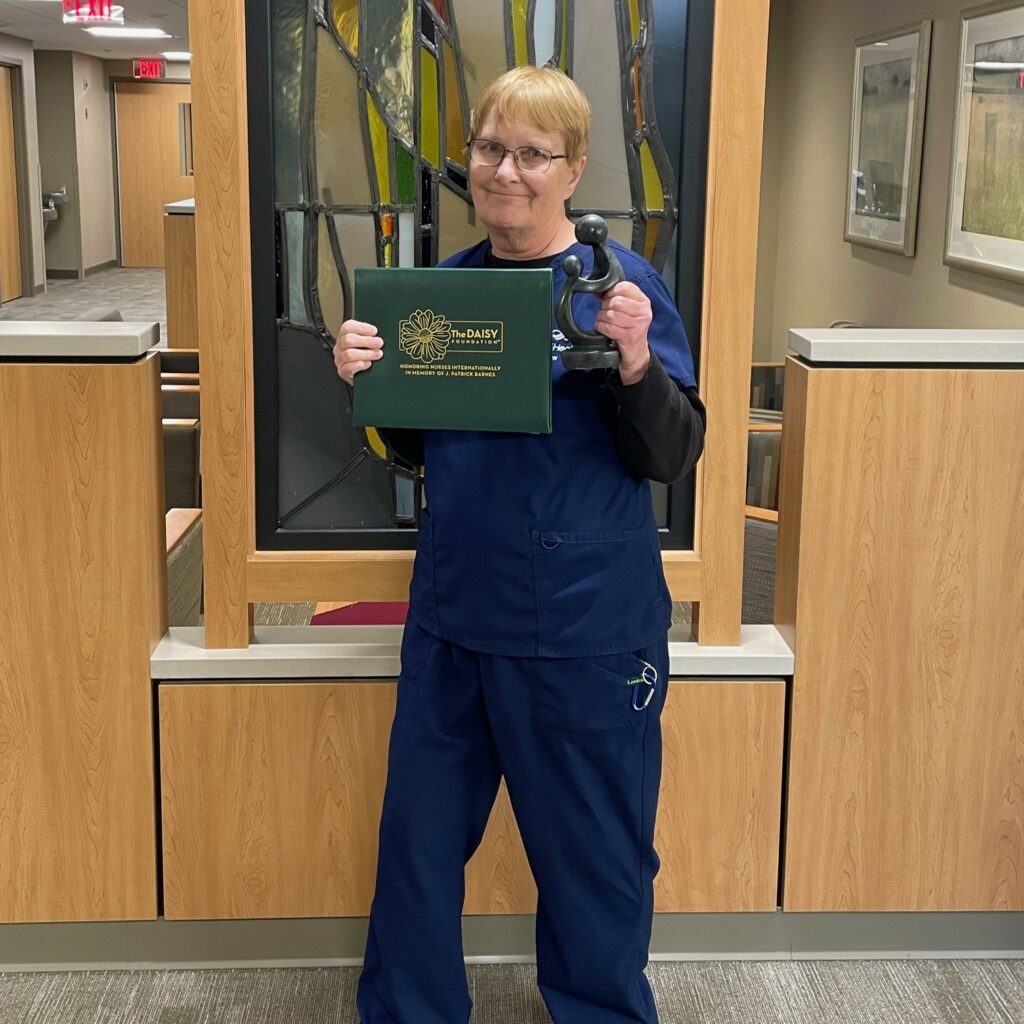 Female nurse holding an award