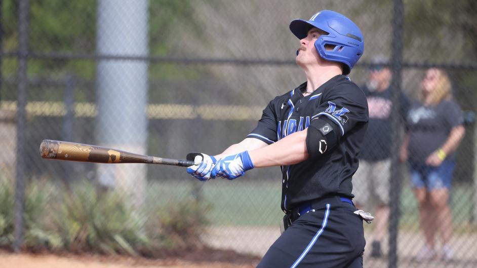 A man batting in a college baseball game