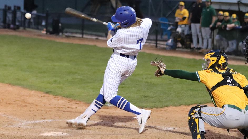 A man batting in a college baseball game
