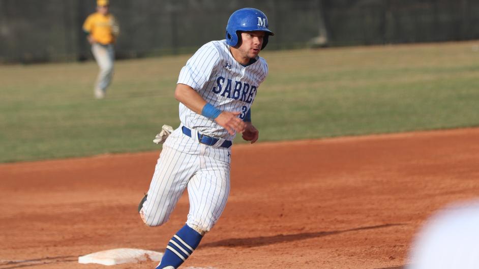 A man running the bases in a college baseball game