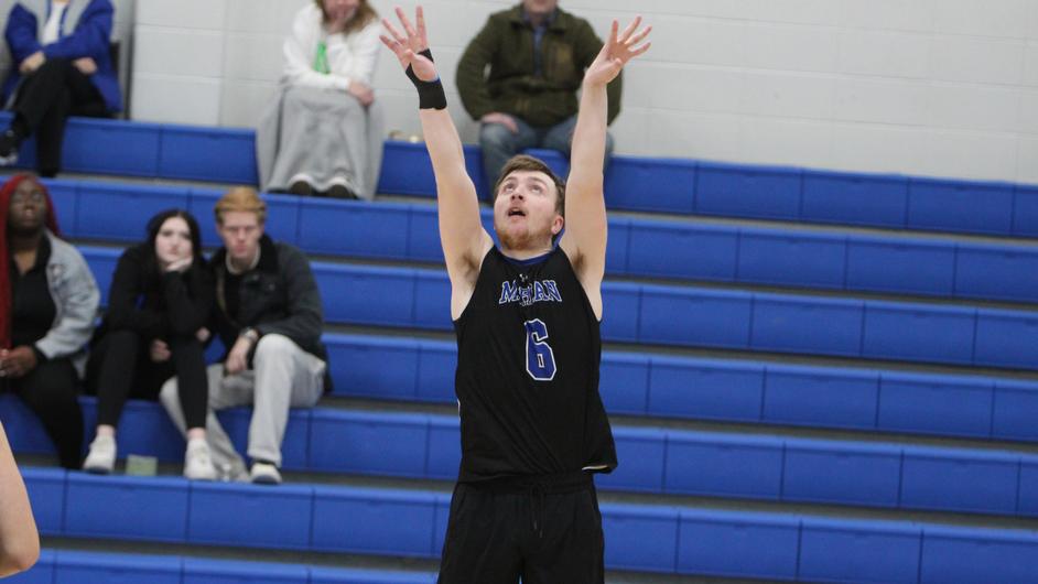 A man playing college volleyball