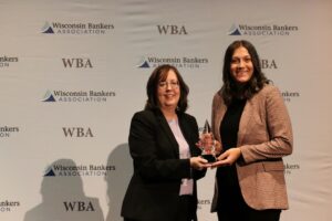 Two woman with an award