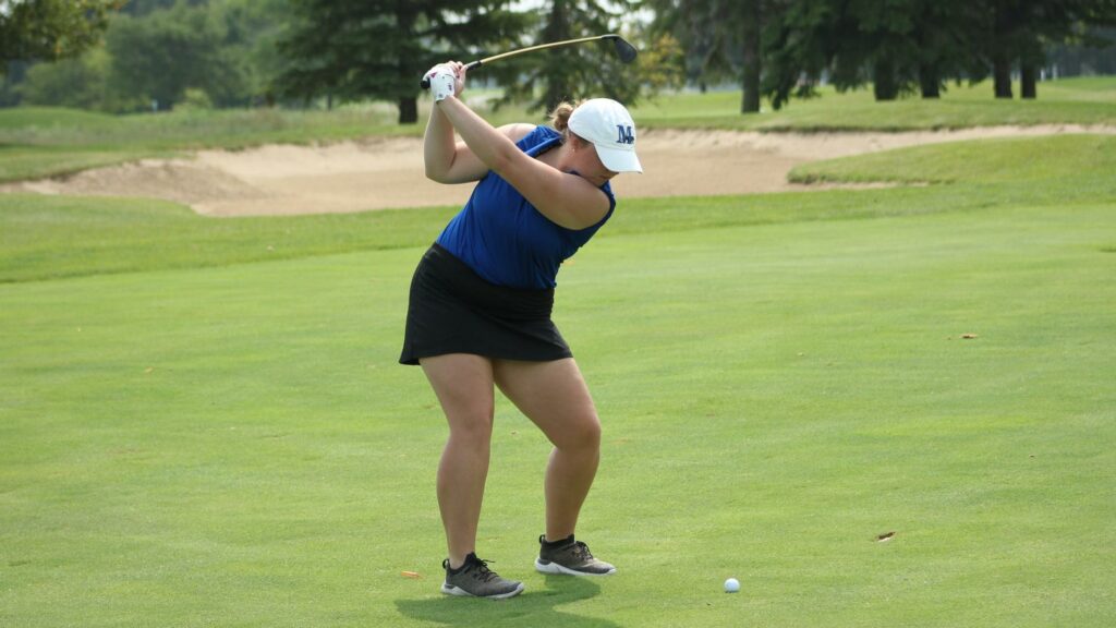 A woman golfing
