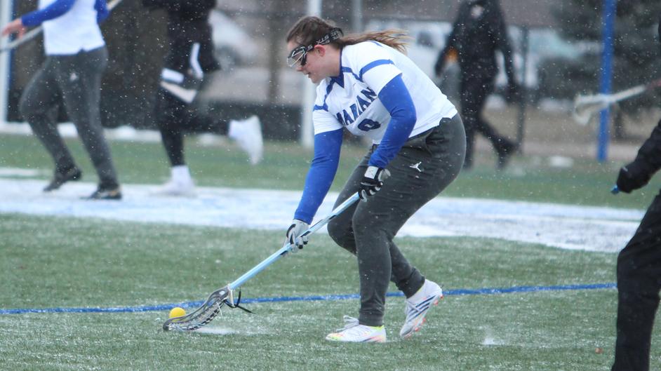 A woman playing college lacrosse