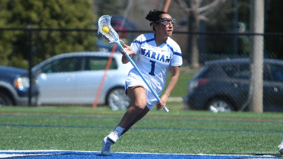 A woman playing college lacrosse