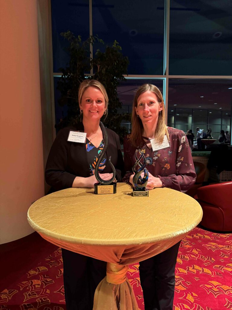 Two women with two trophies
