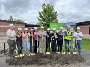 A group of adults with shovels at a ground breaking