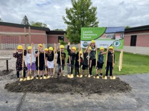 A group of kids with shovels at a ground breaking