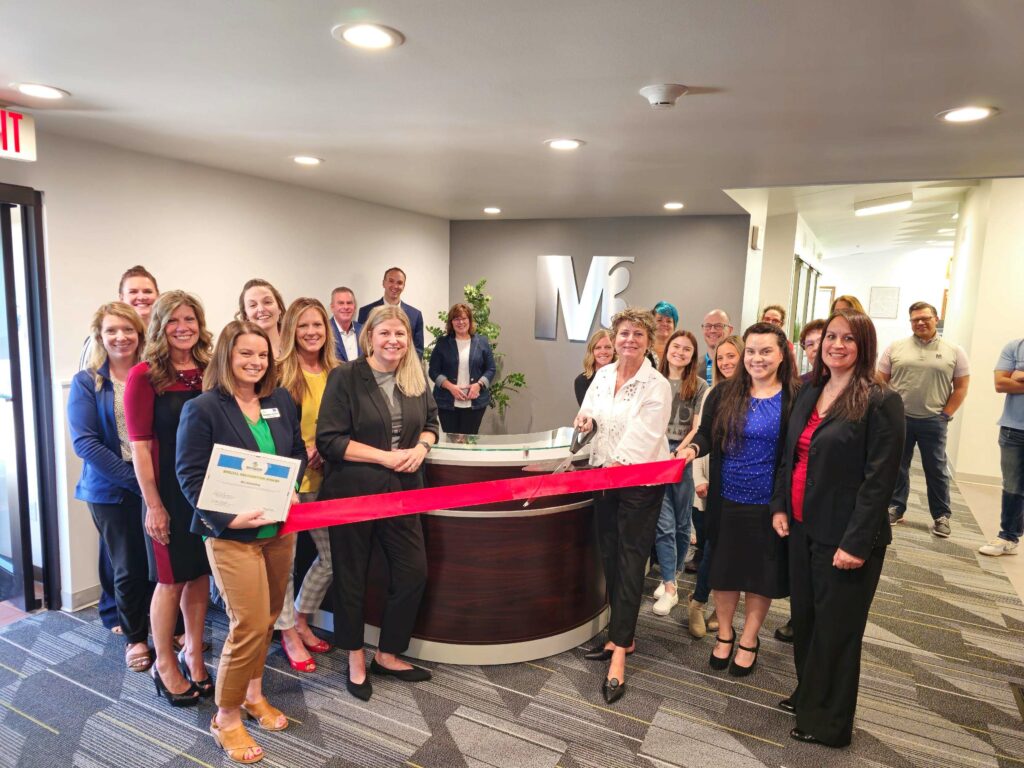 A large group inside for a ribbon cutting