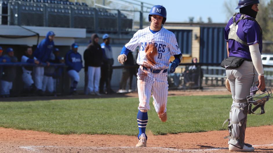 A man running the bases in a college baseball game