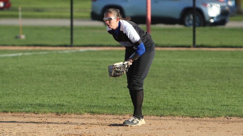 Woman pitching in a college softball game