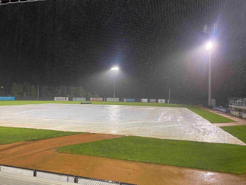 Rain soaked tarp on a baseball diamond