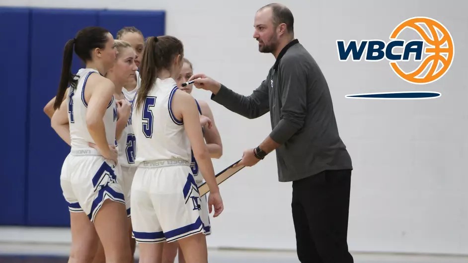 Female basketball players and their coach