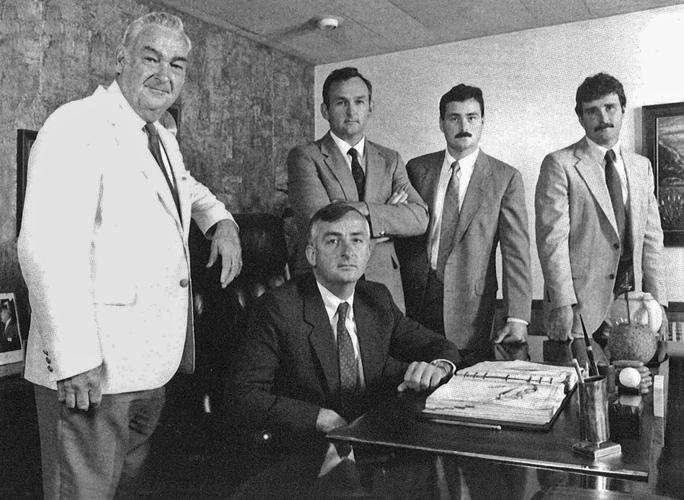 A group of 5 men in an office