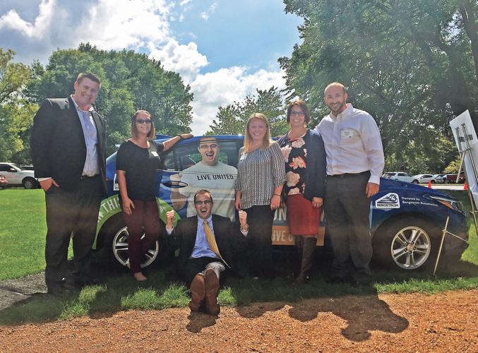 A group of people by a car