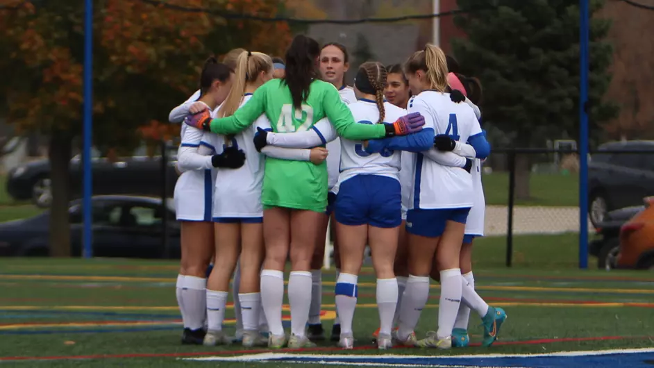 A group of female soccer players hugging