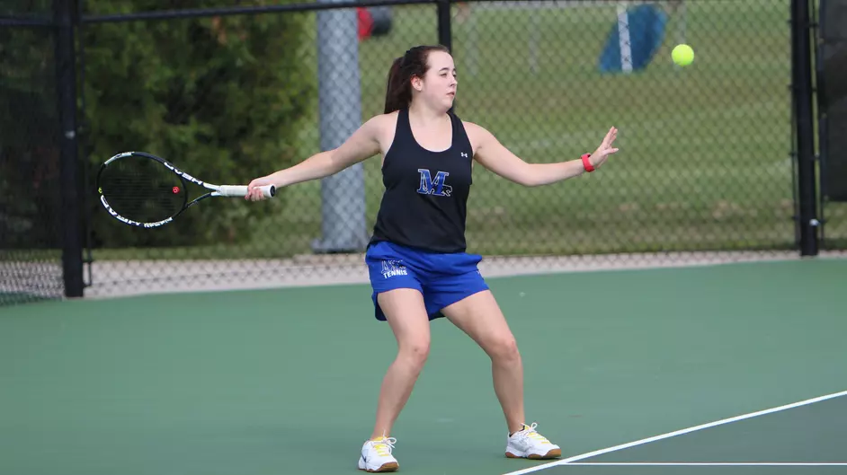A college woman playing tennis