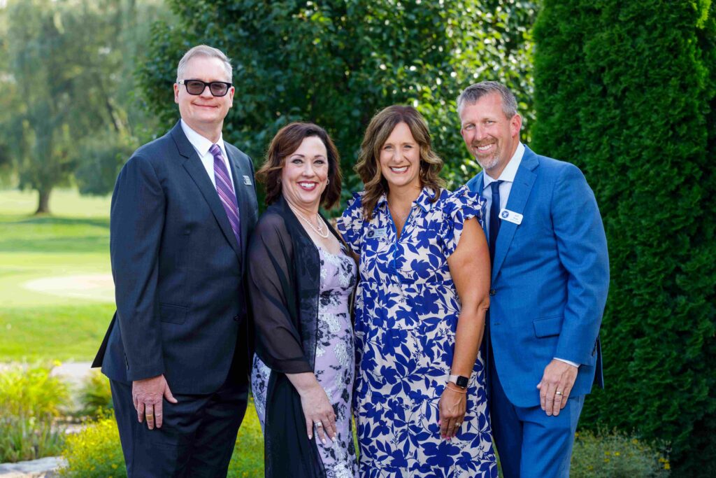 Four adults dressed up outside