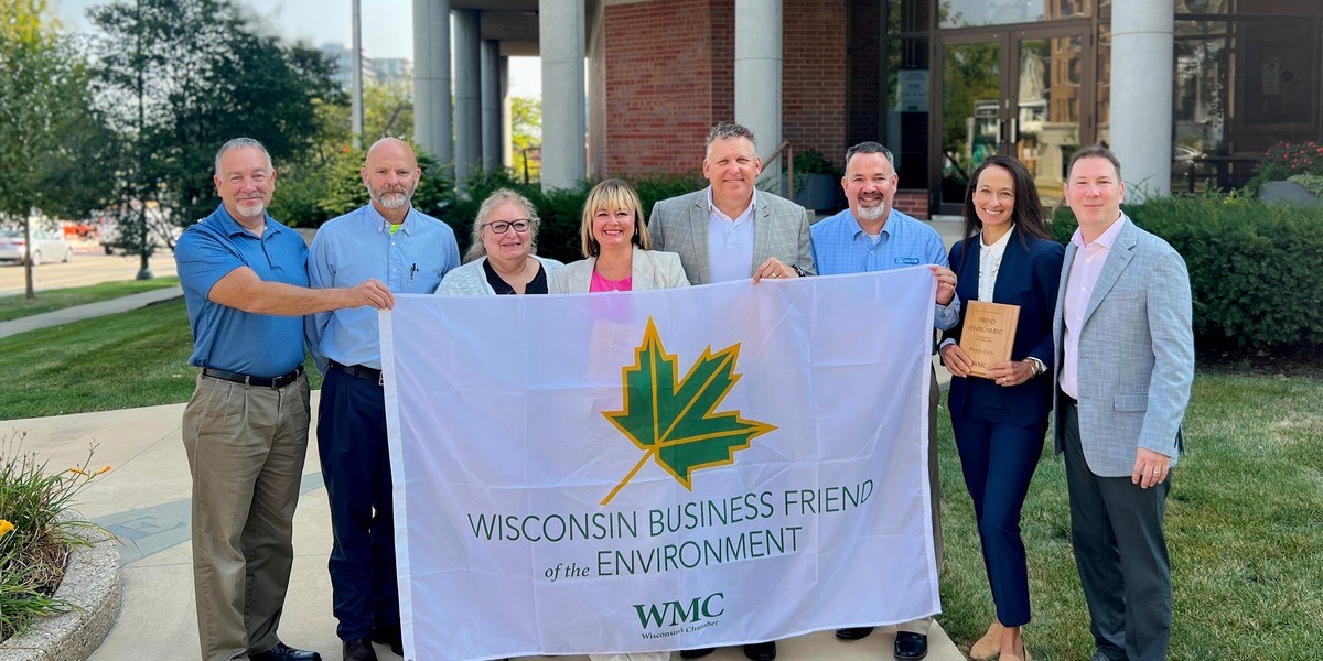 Eight people with a large flag