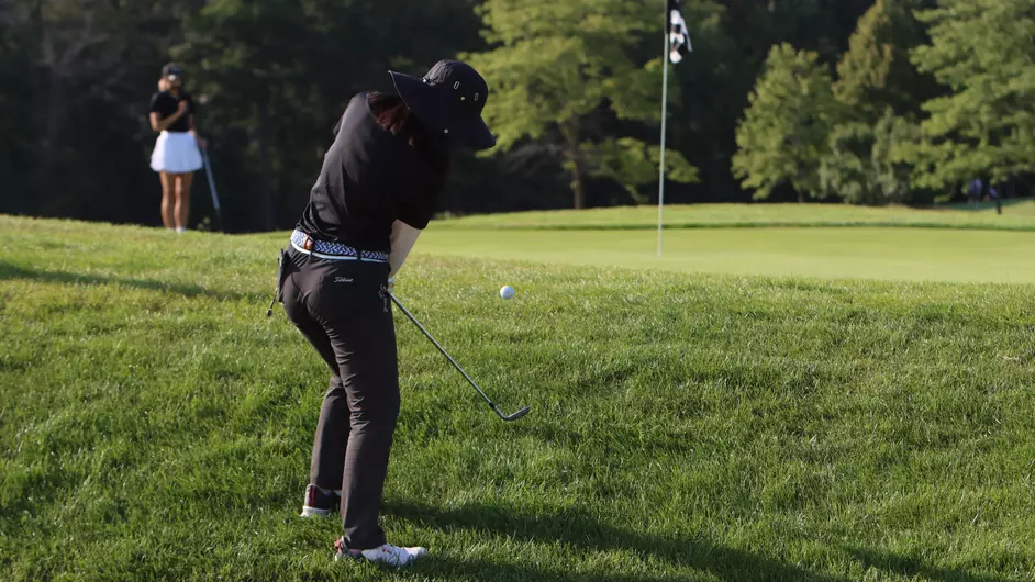 A woman golfing