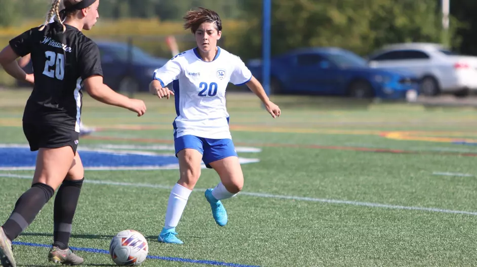 Women playing college soccer