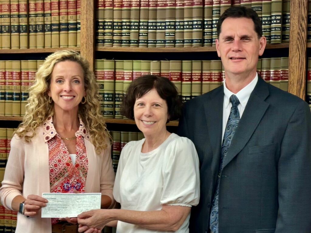 Three people with a check