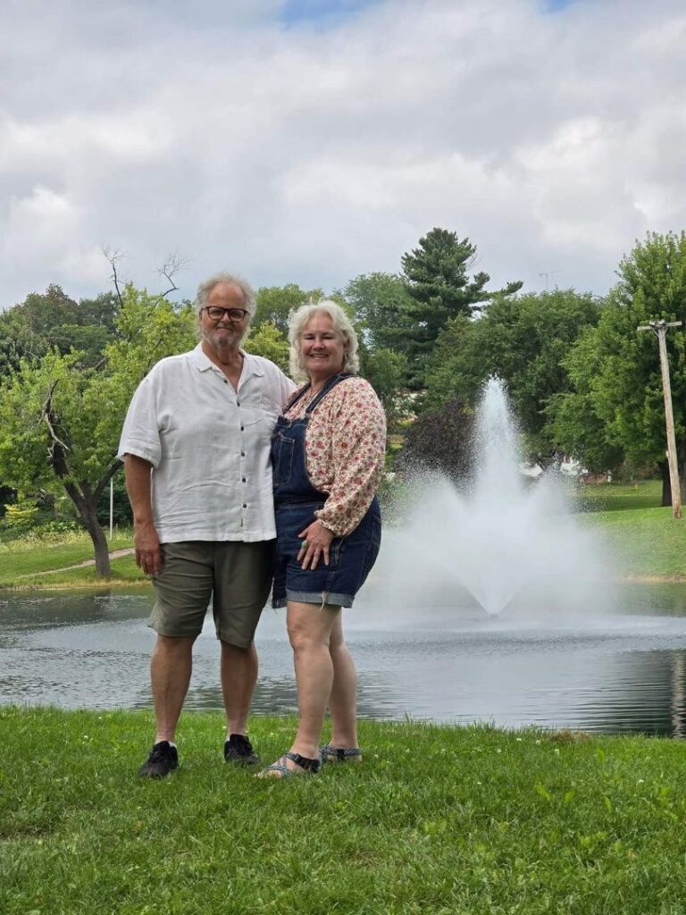 A couple standing by a fountain