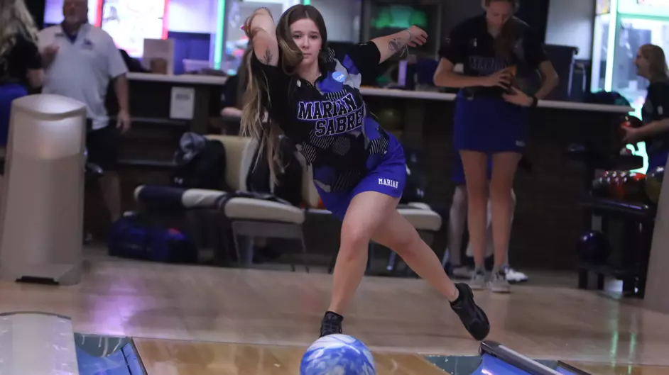 A woman bowling for her college team