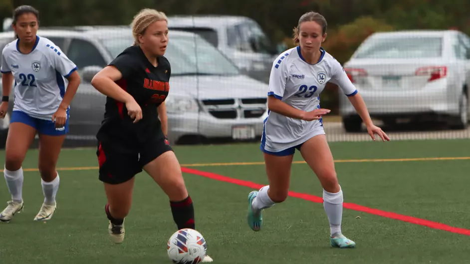 Women playing college soccer