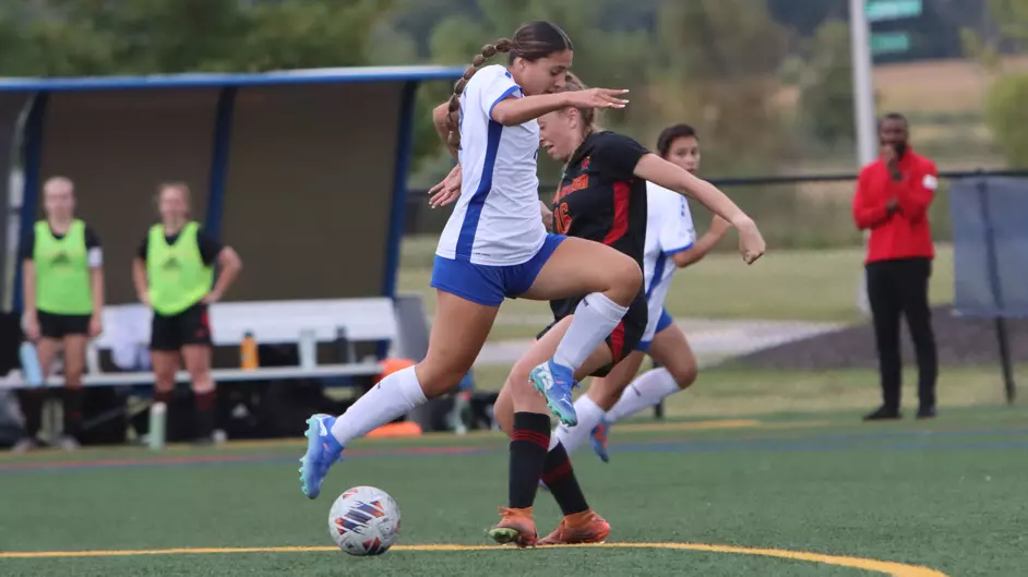 Women playing college soccer