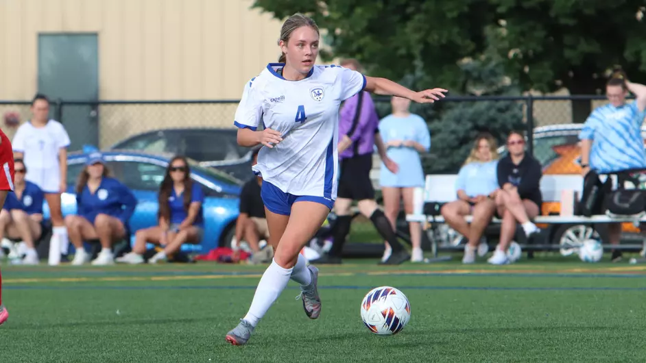 Women playing college soccer