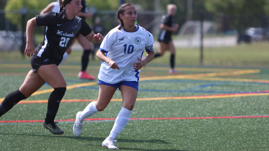 women playing college soccer