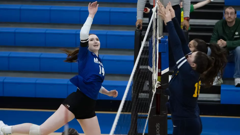 Women playing college volleyball