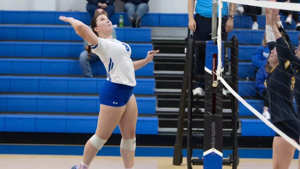 Women playing college volleyball
