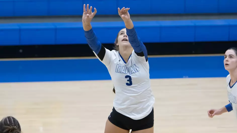 Women playing college volleyball