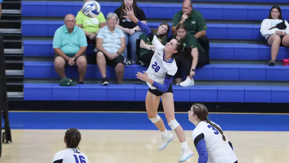 women playing college volleyball