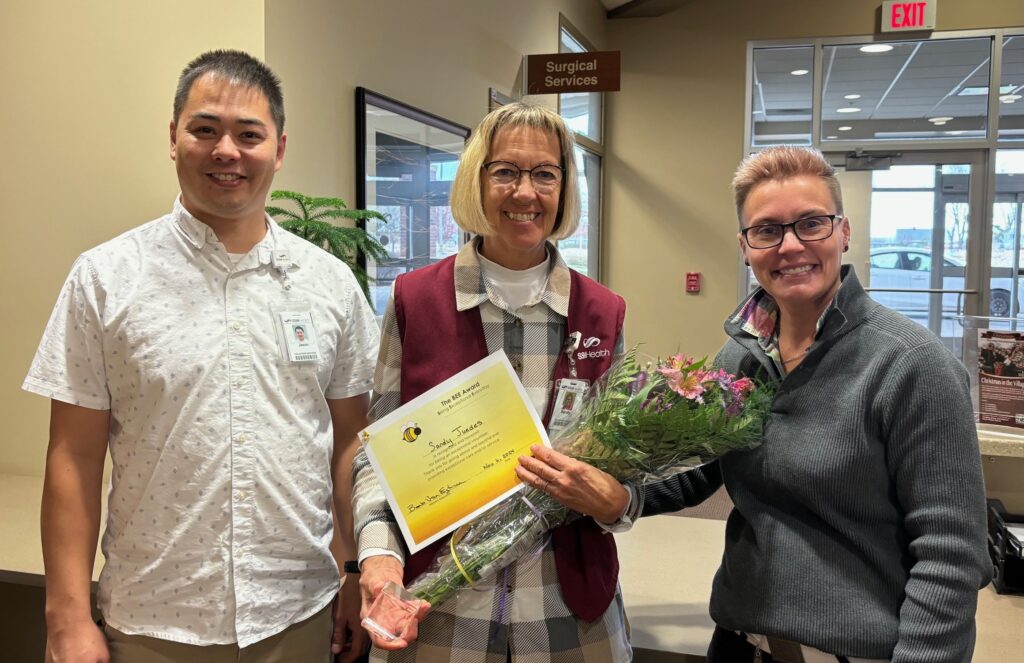 Three people. One with flowers