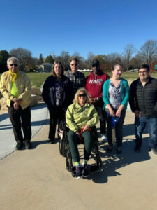Six people outside by a park