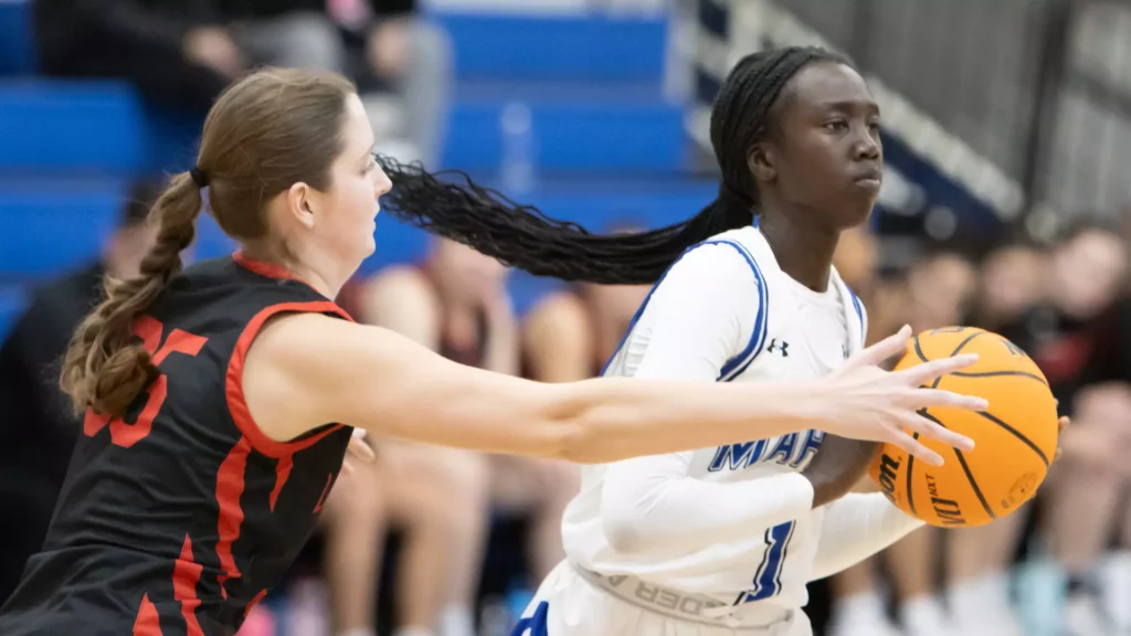Two women playing college basketball