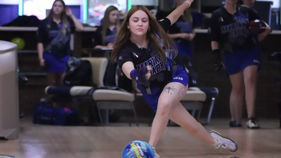 A woman bowling for a college team