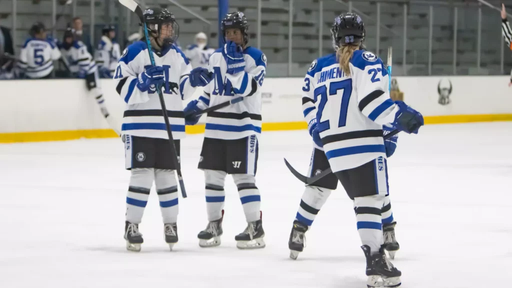 women playing college hockey