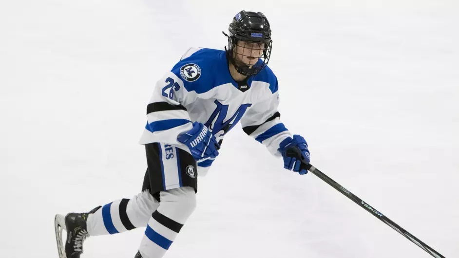 A woman playing college hockey