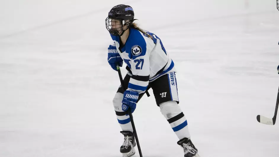 A woman playing hockey