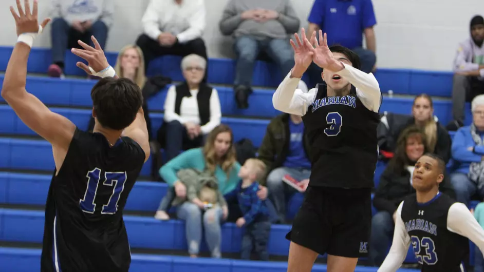Men playing college volleyball