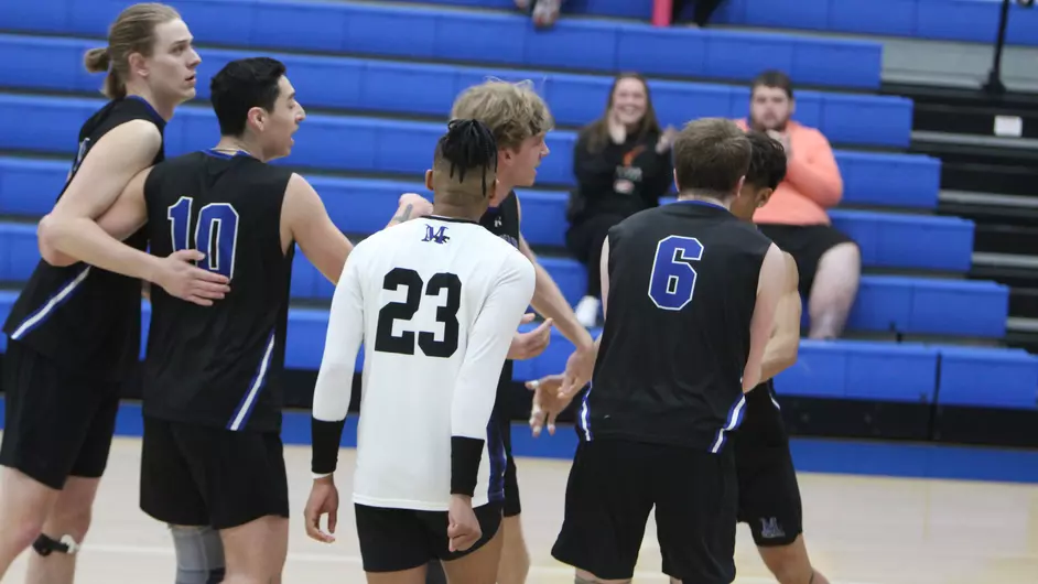 Men playing college volleyball